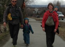 Ground Truth Trekkers Erin and Hig walking with son Katmai and daughter Lituya getting a ride