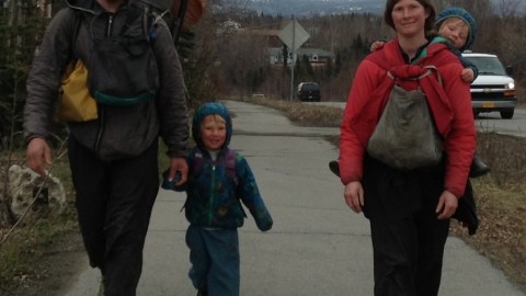 Ground Truth Trekkers Erin and Hig walking with son Katmai and daughter Lituya getting a ride